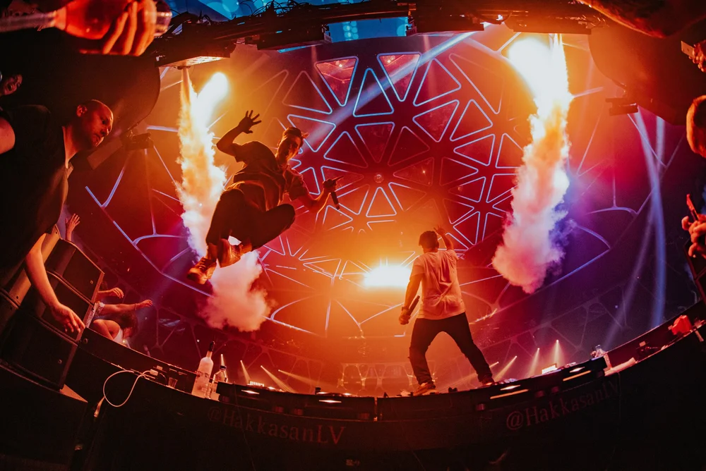 Performers surrounded by columns of fire