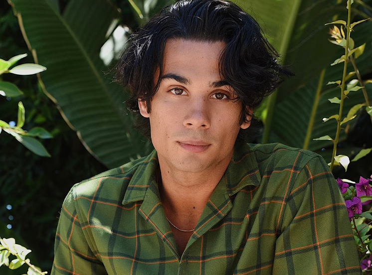 A portrait framed by green leaves